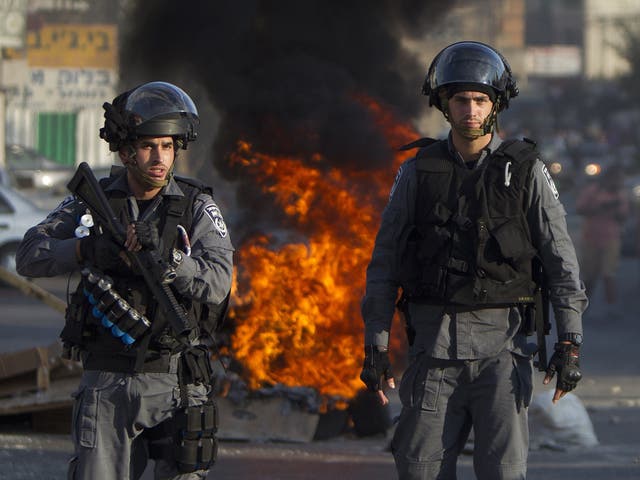 Israeli riot police keep watch during clashes that followed a protest against Israel's military offensive on the Gaza Strip, in the northern city of Nazareth 