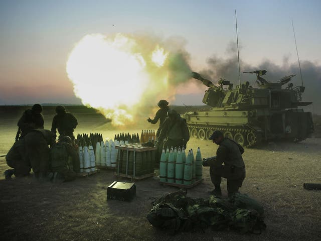 Israeli soldiers of the 155mm artillery cannons unit fire towards the Gaza Strip from their position near Israel's border with the coastal Palestinian enclave 