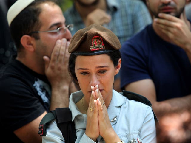 An Israeli female soldier mourns during the funeral of 32-year-old Israeli army captain Tzafrir Bar-Or, a commander of the Golani Brigade killed the previous day fighting a group of Palestinian militants in the Gaza Strip, in the central town of Holon, near Tel Aviv 