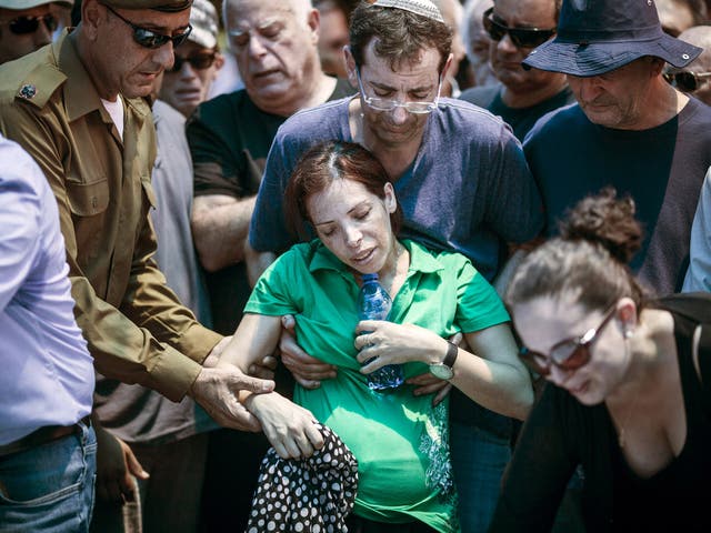 Family members of Major Tsafrir Bar-Or mourn and cry during his funeral in Holon. Major Tsafrir was killed during the operation 'Protective Edge'
