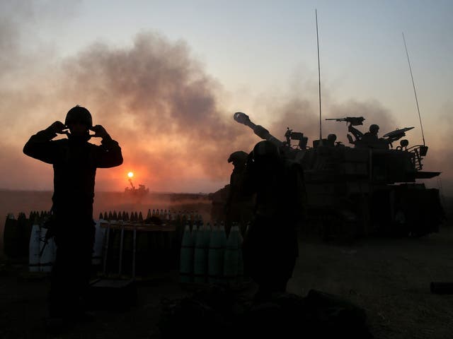 Israeli cannon fires artillery shells from an artillery unit near the Israeli border with Gaza