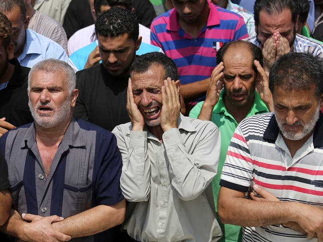 Brothers and family members of Ibrahim al-Kelani, the father and husband of a family of seven with dual Palestinian-German citizenship, attend his funeral in Beit Lahiya town in the northern Gaza Strip 
