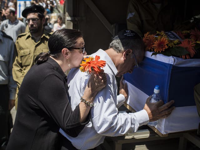 The parents of Sergeant Max Steinberg grieve at his coffin during his funeral in Jerusalem, Israel 