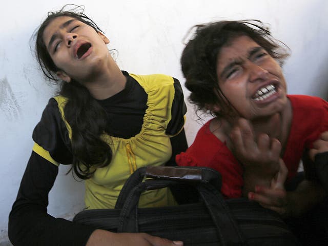 Palestinian girls cry after their father was killed in a UN-operated school after an alleged Israeli attack in Beit Hanun town, northern Gaza strip  