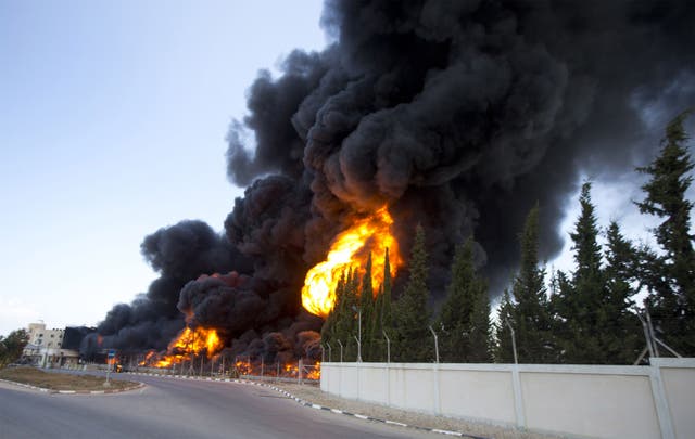 Flames engulf the fuel tanks of the only power plant supplying electricity to the Gaza Strip after it was hit by overnight Israeli shelling, in the south of Gaza City