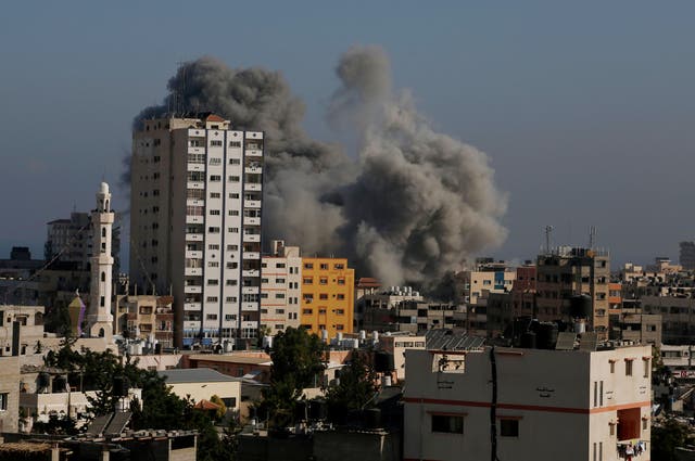 Smoke and fire from the explosion of an Israeli strike rise over Gaza City amid Israel's heaviest air and artillery assault in more than three weeks of Israel-Hamas fighting