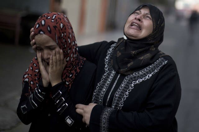 Palestinians who lost relatives in an Israeli strike on a compound housing a UN school in Jabalia refugee camp in the northern Gaza Strip, mourn outside the Kamal Edwin hospital in Beit Lahia