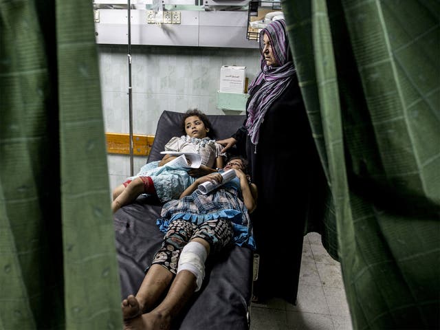 Palestinian civilians wounded during Israeli shelling in a UN school wait at the Kamal Adwan hospital in Beit Lahia 