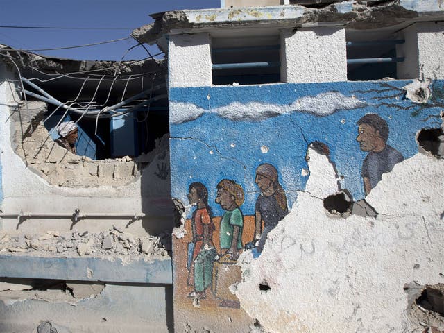 A Palestinian man inspects the damage at a UN school at the Jabalia refugee camp in the northern Gaza Strip