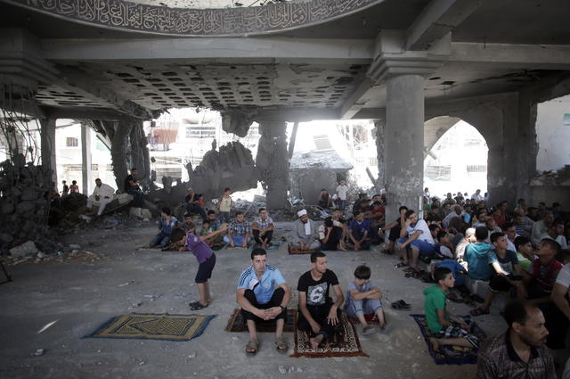 Palestinians attend Friday noon prayers in a destroyed mosque that was hit by Israeli strikes, in Gaza City, as Israel and Gaza militants resumed cross-border attacks after a three-day truce expired and Egyptian-brokered talks on a new border deal for blockaded Gaza hit a deadlock