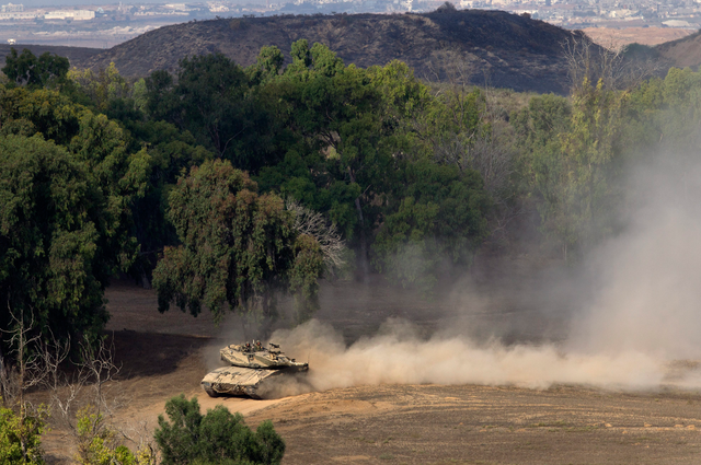 An Israeli Merkava tank moves along a road near the border with the Gaza Strip, Southern Israel