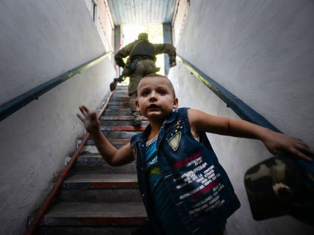 A boy ascends the stairs of a bomb shelter after the shelling in the Petrovskiy district in Donetsk