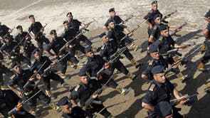 Members of Hamas security forces march during their graduation ceremony at the fisherman's port in Gaza City