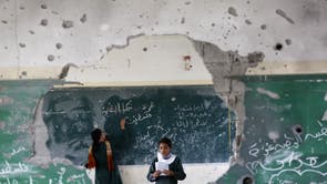 Palestinian girls play inside their school which was destroyed during the 50 days of conflict between Israel and Hamas last summer, in the Shejaiya neighborhood of Gaza City