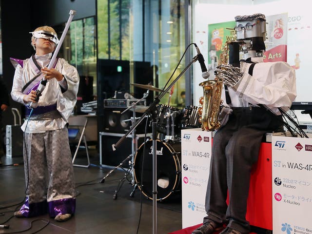Waseda University's saxophonist robot WAS-5, developed by professor Atsuo Takanishi and Kaptain Rock playing one string light saber guitar perform jam session