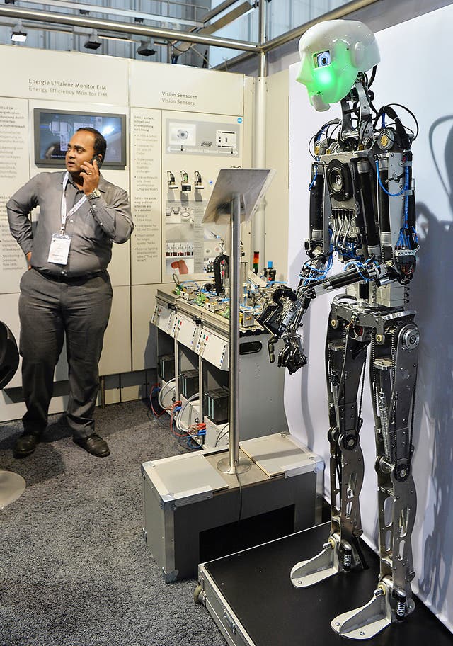A humanoid robot gestures during a demo at a stall in the Indian Machine Tools Expo, IMTEX/Tooltech 2017 held in Bangalore