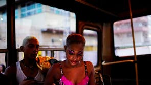A dancer uses a hotspot from inside a bus before performing at the Carnival of Havana