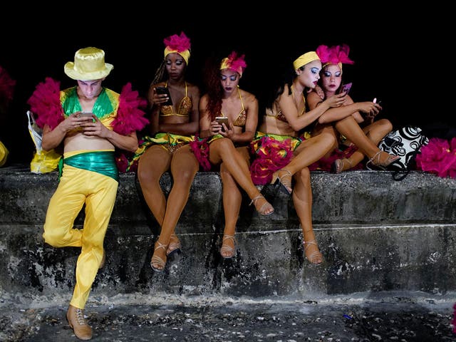 Dancers use a hotspot before performing at the Carnival of Havana