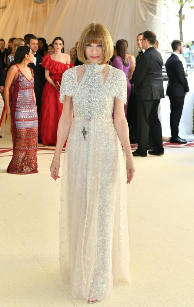 Vogue editor Anna Wintour wears a custom Chanel gown featuring a halter neck and intricate beading