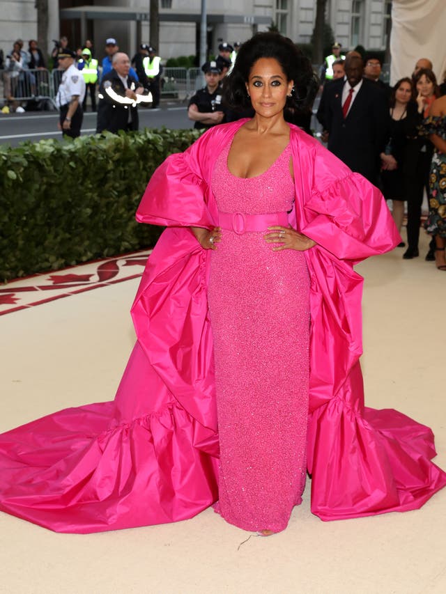 Tracee Ellis Ross wears a bright pink gown with a matching jacket by Michael Kors