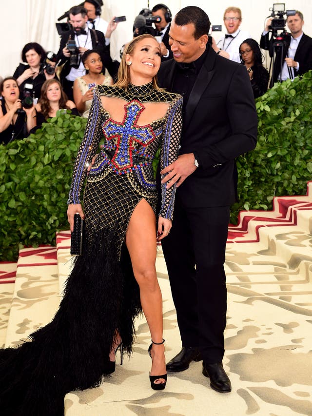 Jennifer Lopez wears a bejewelled Balmain gown with cross detailing while Alex Rodriguez opted for a polished black suit