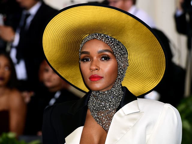 Janelle Monae wears a monochrome Marc Jacobs gown with a crystallised head wrap and Stephen Jones hat