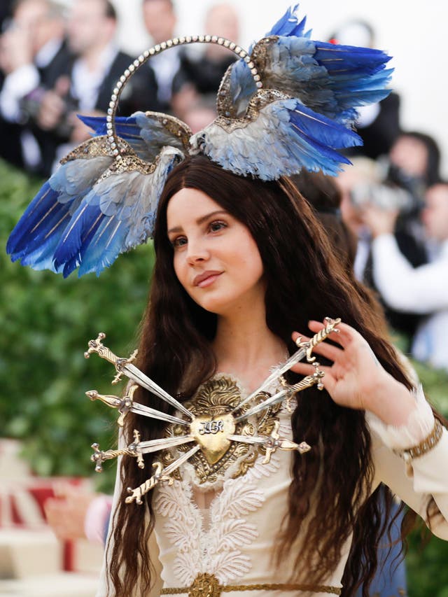 Lana Del Rey wears an elaborate Gucci gown and bird halo headpiece