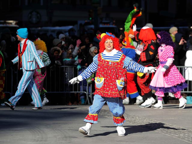 A clown performs in the parade
