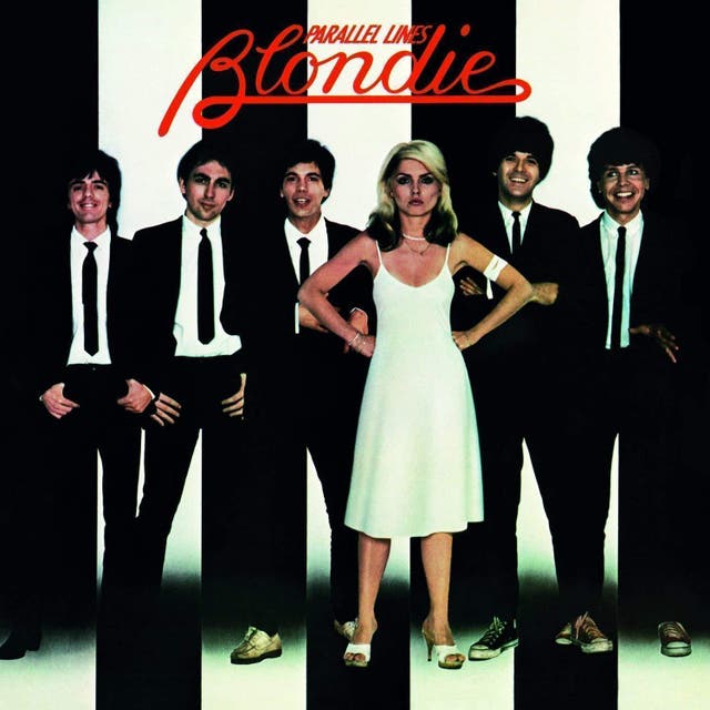 Visually striking and symbolic of what Debbie Harry was doing both as a woman and an artist in the music industry, Parallel Lines’ cover was shot by photographer Edo Bertoglio. It was apparently rejected by the band but later chosen by their manager, Peter Leeds. The juxtaposition between the band, who beam in their matching dress suits like a bunch of schoolboys at their senior prom, とハリー, who stands defiant in her white dress, hands on hips, is wonderful. “I’m not impressed,” her stance seems to say. “Try harder.”