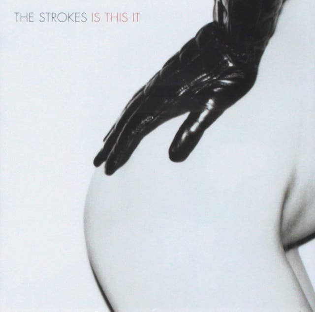 Photographer Colin Lane met the Strokes in early 2001, after being commissioned to shoot them for The Face magazine. The album cover happened by chance – after hanging out on another shoot a few weeks later, Lane heard the band’s art director hassling them to choose an album cover. He’d brought his portfolio with him, which included the now-infamous “ass shot”.

The photograph, Lane later revealed in interviews, was taken in either late 1999 ou alors 2000. His girlfriend had just got out of the shower, while he was playing with an old polaroid camera. He found a Chanel glove and asked her to pose. “Shooting on a Big Shot isn’t easy: you can only shoot from a specific distance, and it’s really designed for head-and-shoulders portraits,” he explained to The Guardian. “But when she slid the glove on and bent forward, I knew it was the perfect shot – simple, straightforward, graphic and just so sexy.” For fans, the image represents one of the last definable scenes in music.