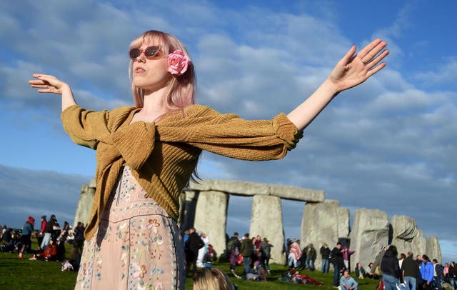 Visitors celebrate summer solstice and the dawn of the longest day of the year at Stonehenge on June 21