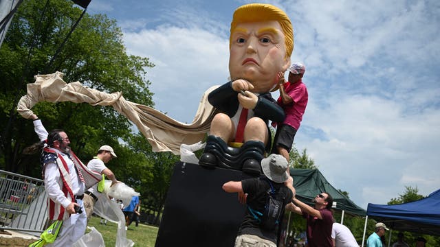 Protesters unveil a statue of US President Donald Trump tweeting on a toilet, at the National Mall ahead of the, "Salute to America" Fourth of July event with US President Donald Trump at the Lincoln Memorial in Washington, DC
