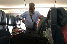 Man stands for six hours on flight so wife can lie across three seats
