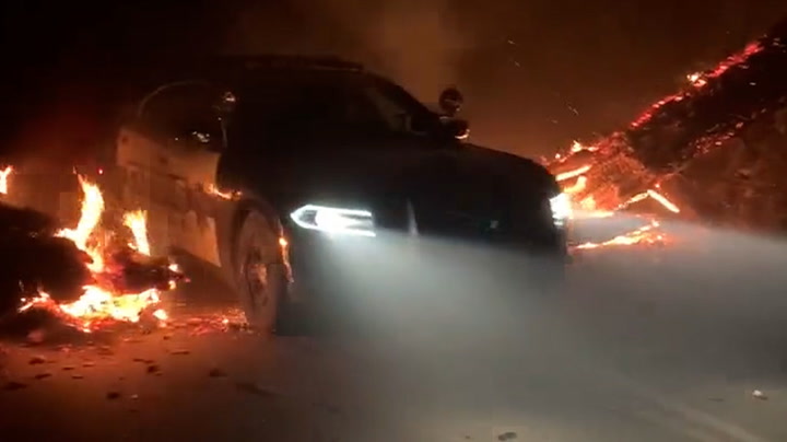 Police car drives through flames as Oak Fire rages in California