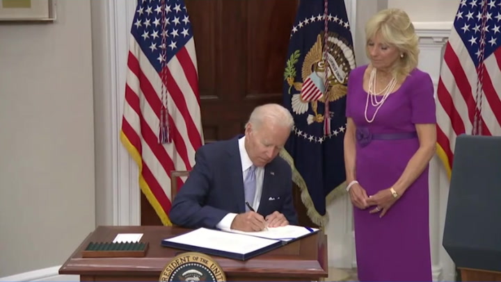 Biden signs historic gun bill into law on ‘monumental day’ for US