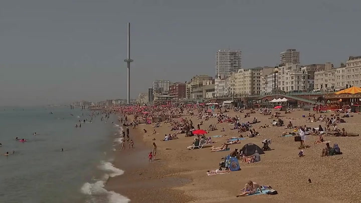 Britons flock to Brighton Beach as European heatwave hits UK