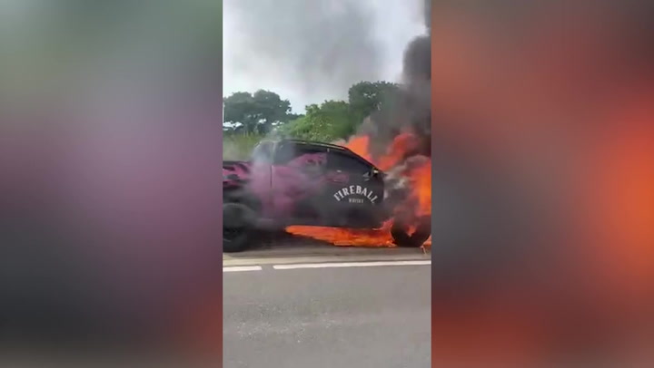 Fireball Whisky truck engulfed by flames on side of motorway