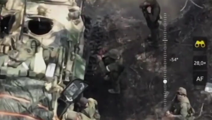Russian soldier gives middle finger to Ukrainian drone before it hits tank