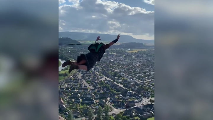 Scottish thrill-seekers base jump from top of Wallace Monument in kilts