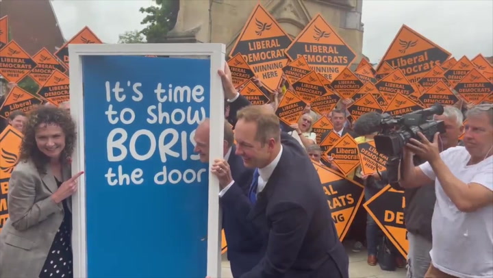 Lib Dems celebrate by-election by unveiling door aimed at Boris to resign