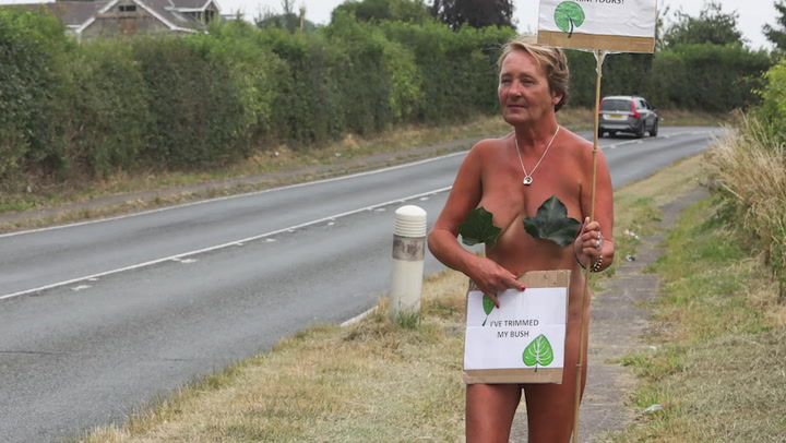 Mother stages naked protest to get hedge trimmed to allow access for disabled daughter