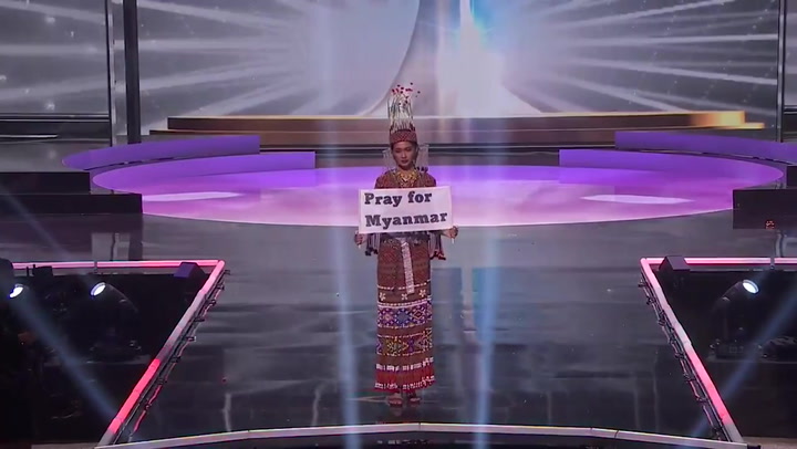 Miss Universe Myanmar contestant holds 'Pray for Myanmar' sign