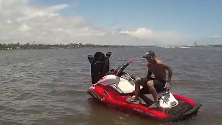 Police officers borrow boat to chase after suspect on stolen jet ski
