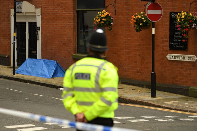 A police officer guards a cordon at the scene in Birmingham city centre.