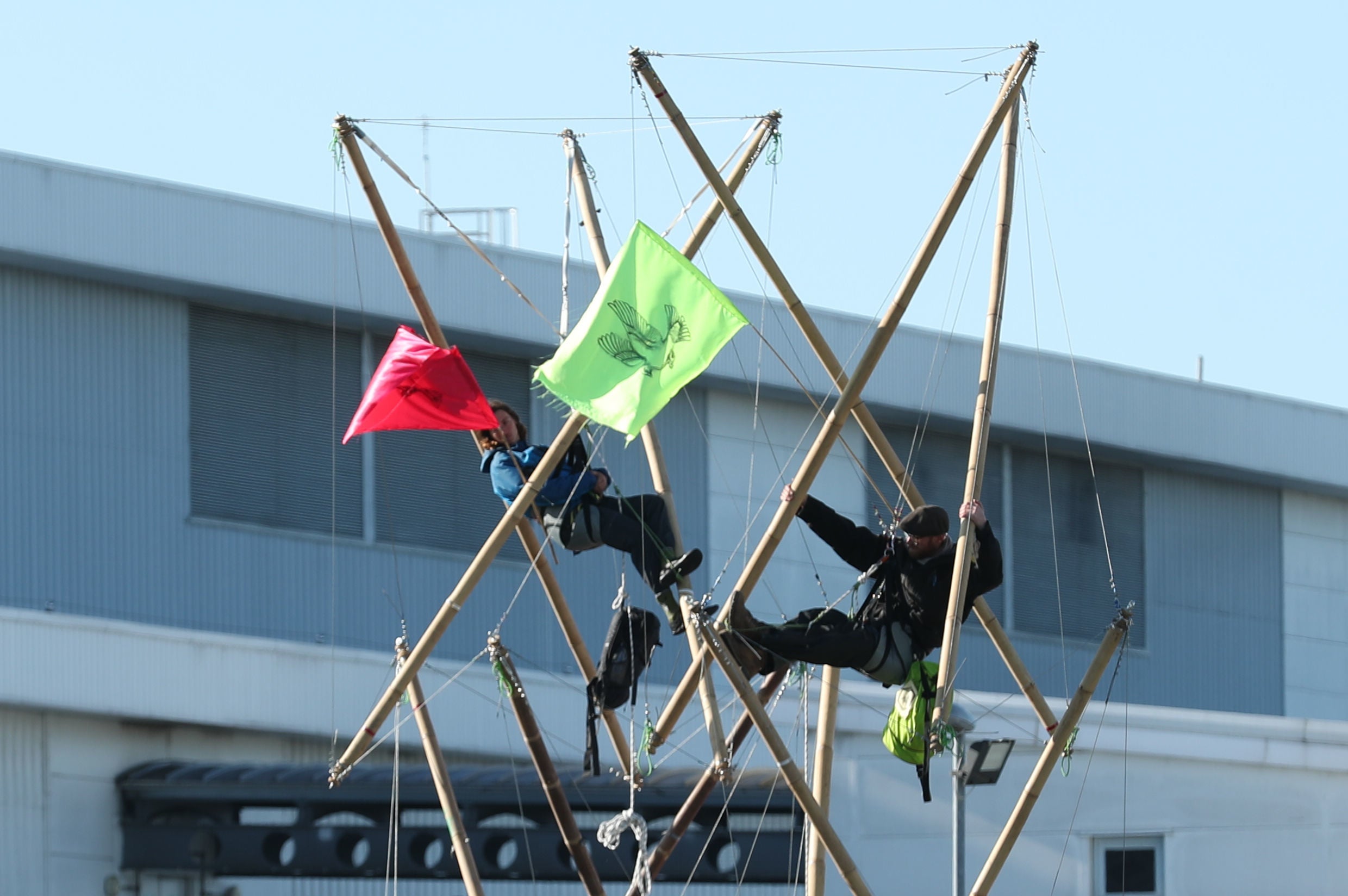 Protesters lock themselves on to bamboo structures outside the Newsprinters plant in Waltham Cross
