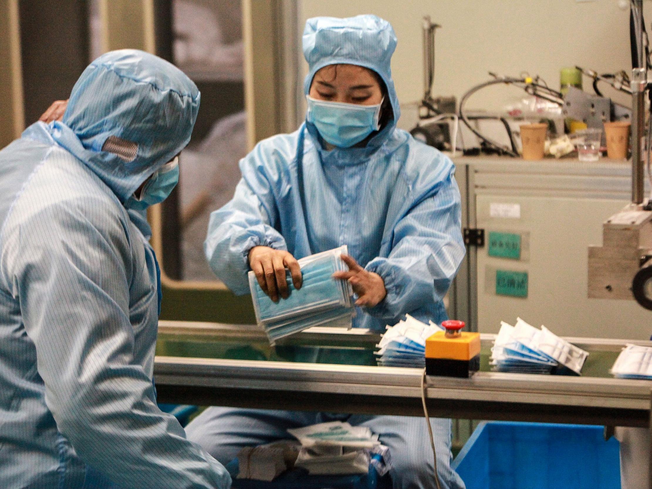 Workers prepare PPE at a factory in Yangzhou, China