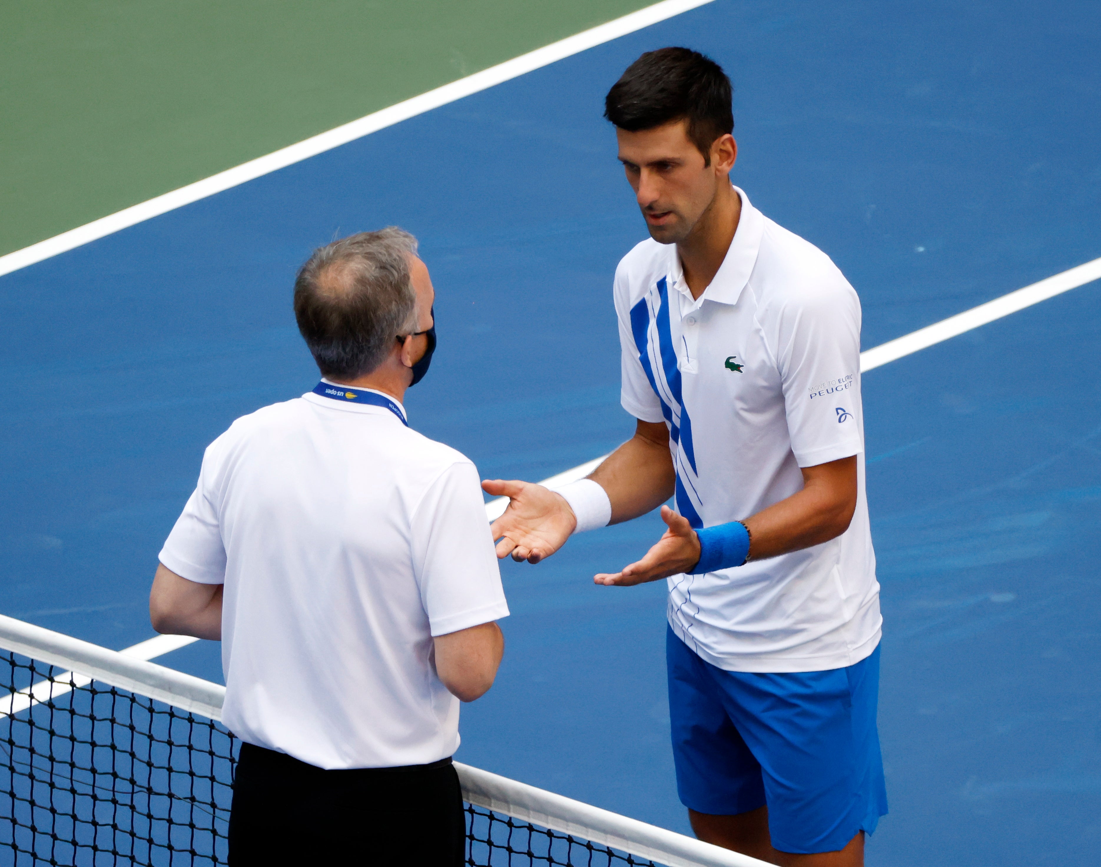 Novak Djokovic talks to Head of Officiating at the ITF Soeren Friemel 