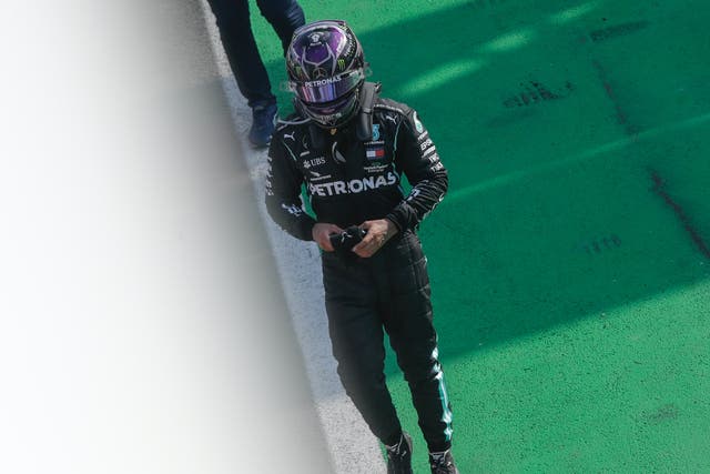 Mercedes driver Lewis Hamilton walks after completing the Italian Formula One Grand Prix