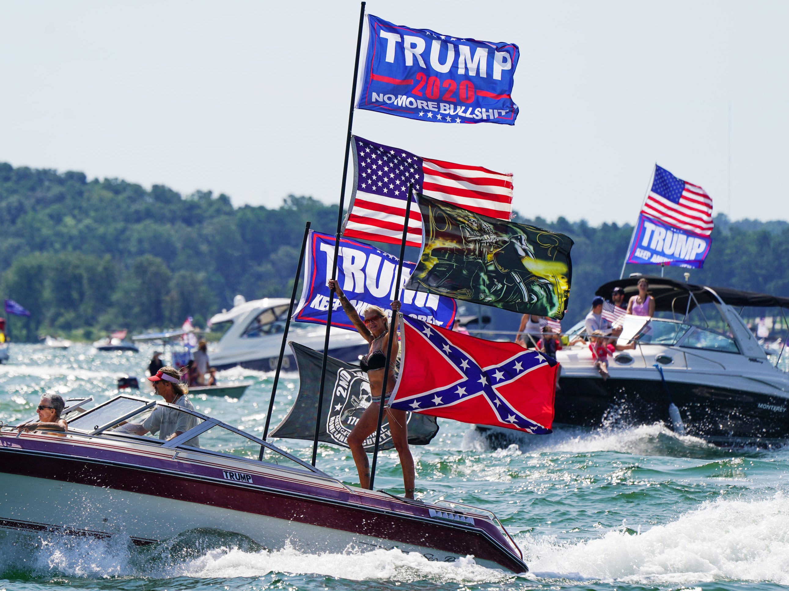 Boats adorned with US and Trump campaign flags are seen on Lake Lanier during a 'Great American Boat Parade' in Georgia