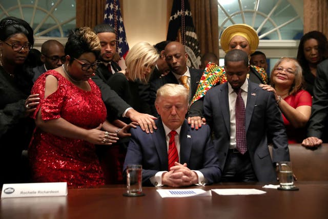 Supporters pray over Donald Trump at the White House